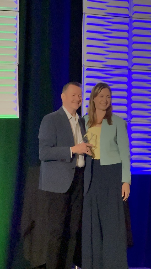 Curt accepts award from EMDRIA Board President Holly Forman-Patel